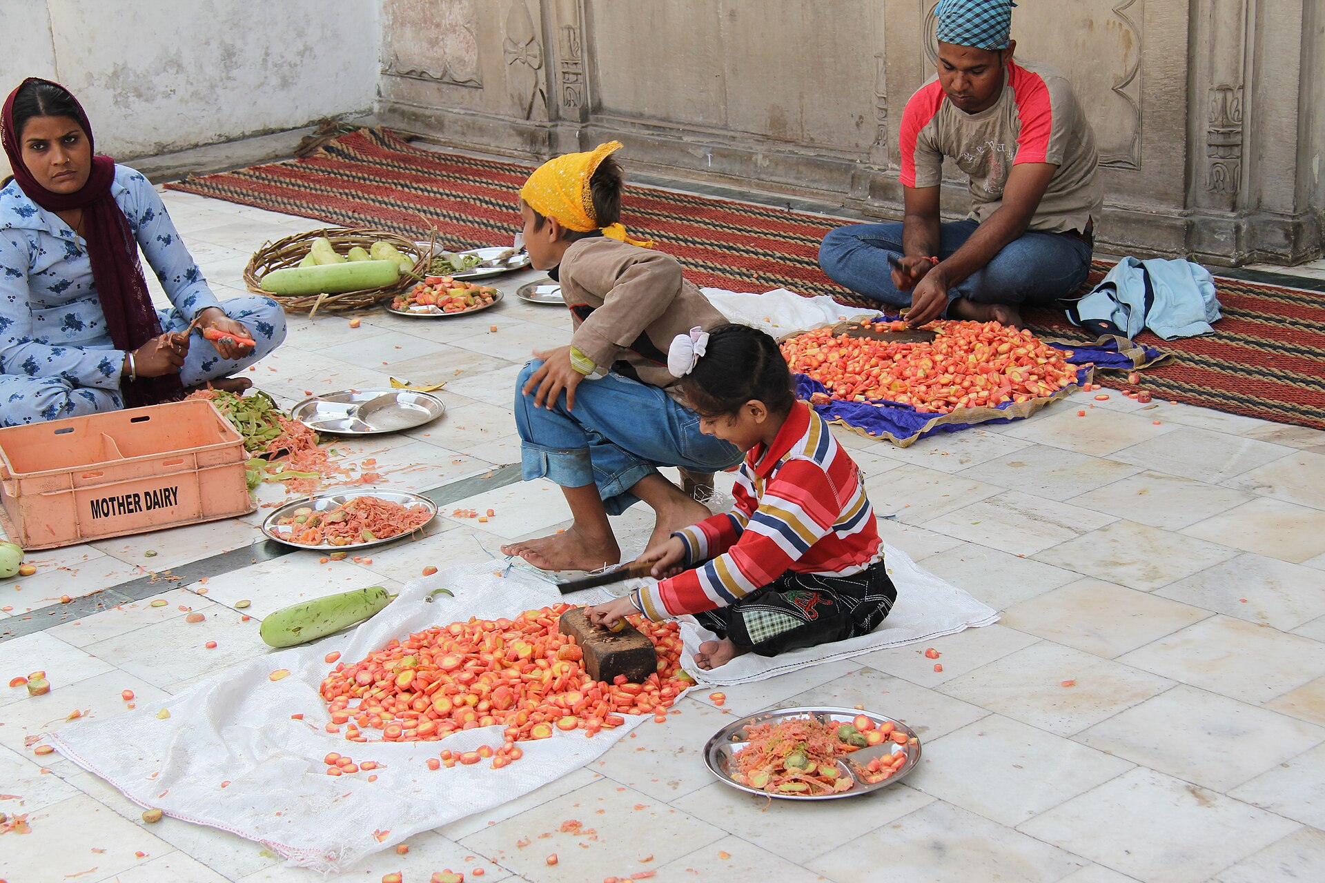 A family preparing rotis for langar